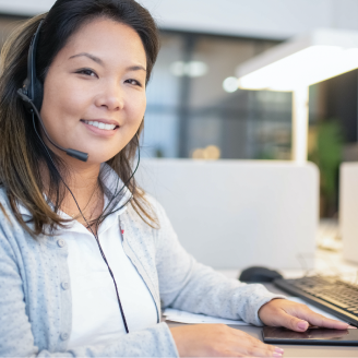 Person with a headset working at a computer